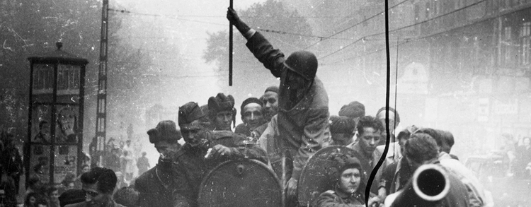 Old black and white photo with crowd of soldiers riding a tank
