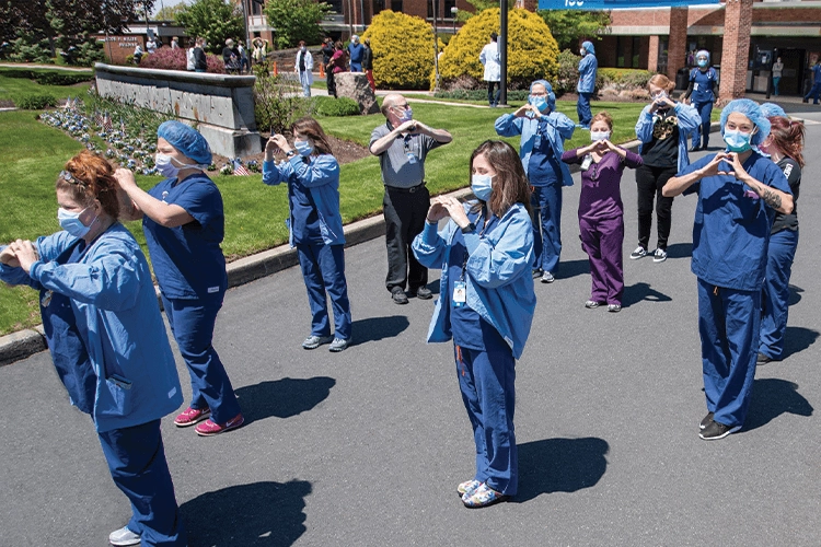 Medic standing with heart shaped hands