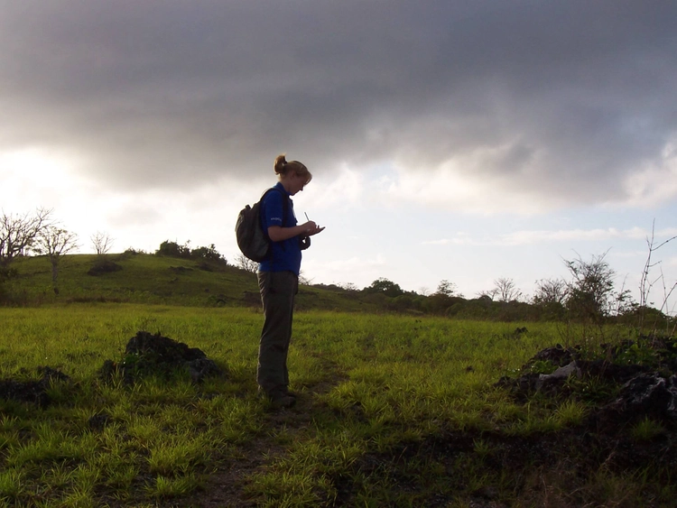 A student note taking in a field