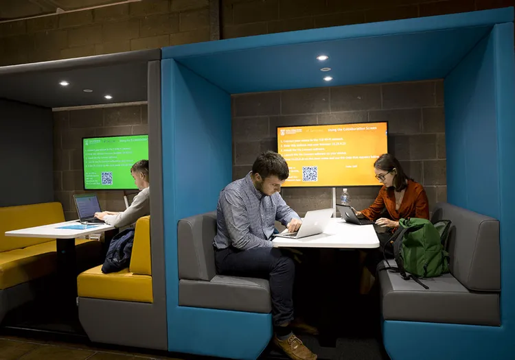 image of two students studying with computers in Huddle Spaces