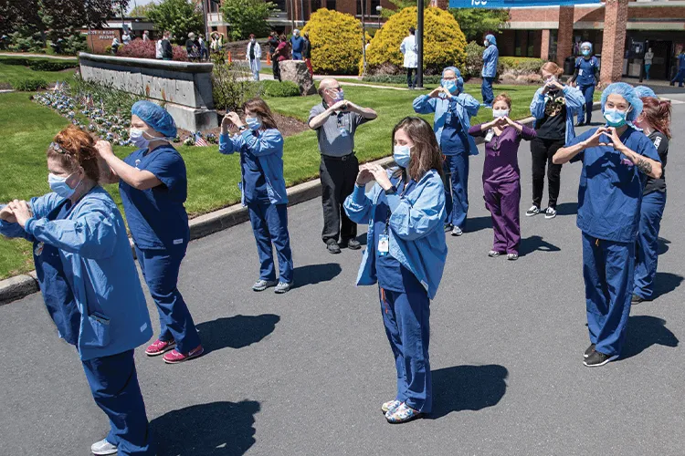 Medic standing with heart shaped hands