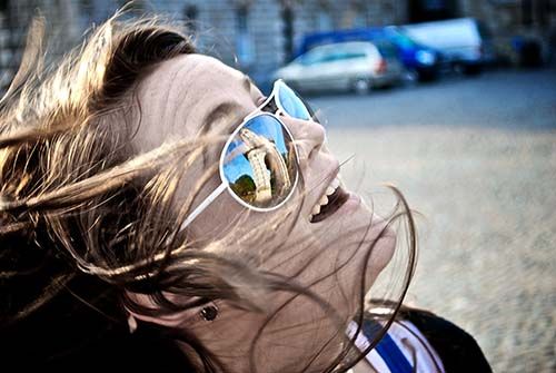 A student looking up with reflection on glasses