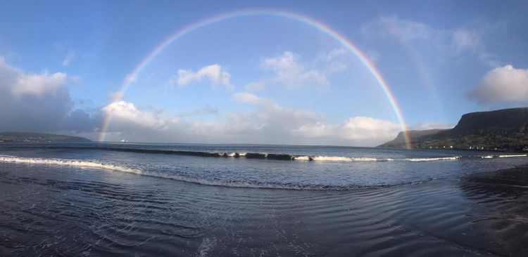 A rainbow over a lake