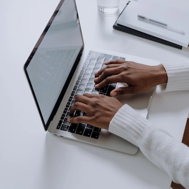 A person typing at a computer