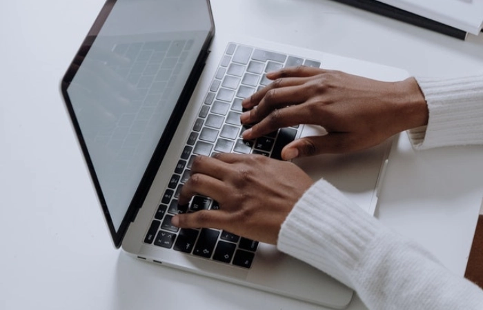 A person typing on a laptop