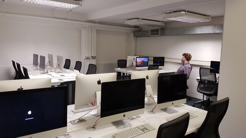 Image of person sitting in a Mac Lab