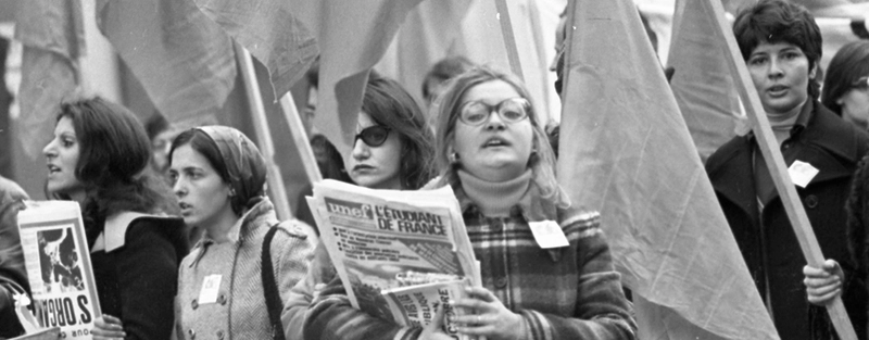 Group of women in the 60s holding flags