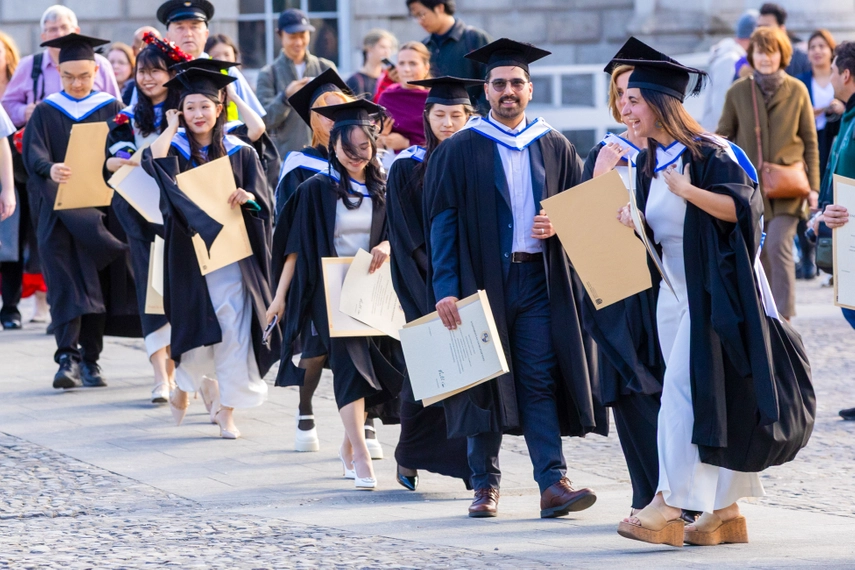 Students walking across for the group photo