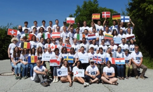 Students taking part in Summer School Alpach 2022. Mikhail Vaganov is pictured holding the Irish flag
