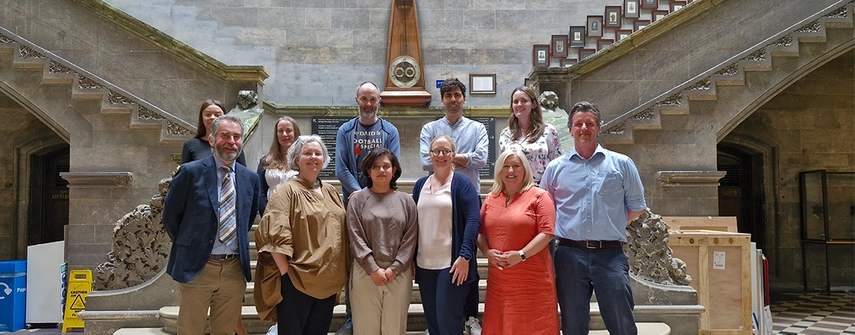 A group of people in front of the stairs of the Museum Building