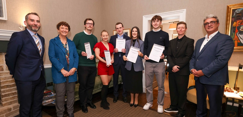 A group of students receiving their scholarship certificates