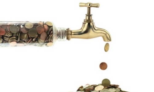 A stock image of coins pouring out of a tap