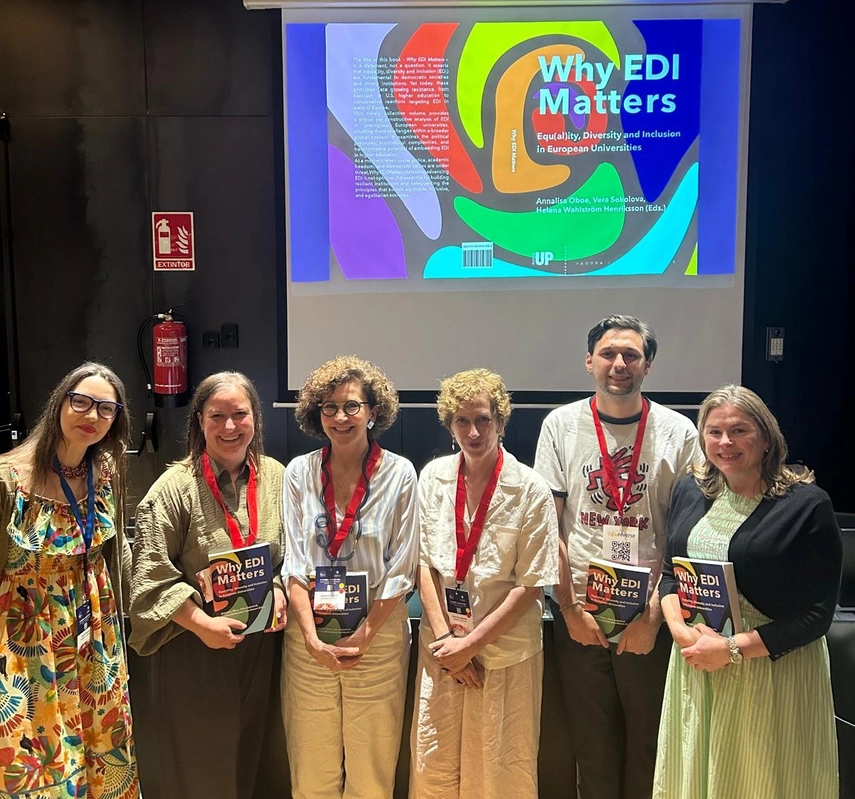 a group of people holding books in front of a slide displaying their book cover