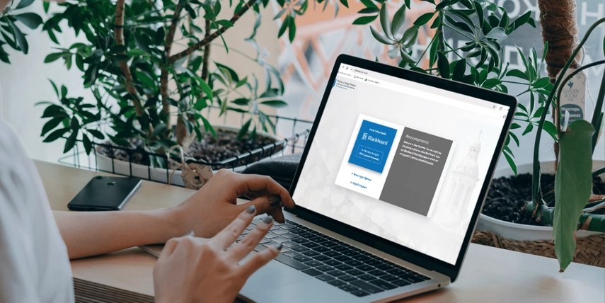 Image of hands working on laptop with Blackboard login screen open