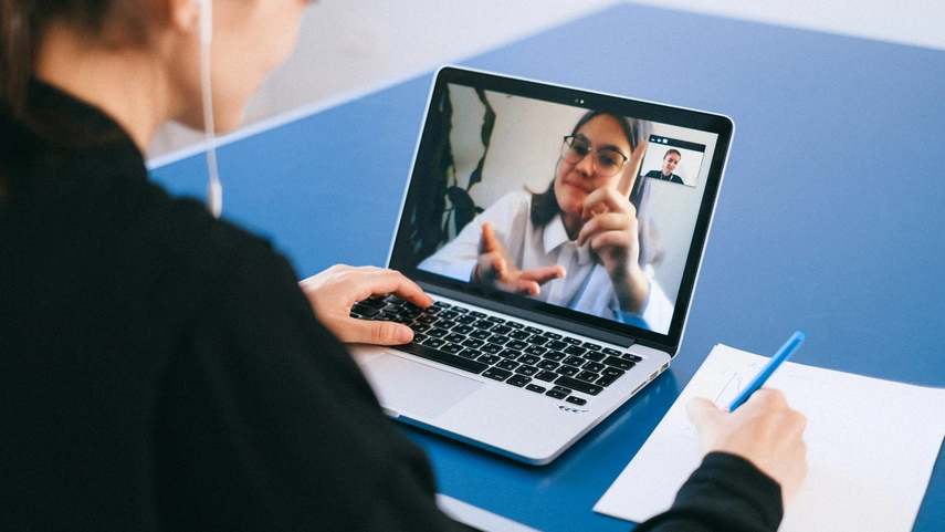 Person talking to another person via video call on laptop