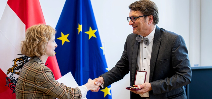 Clemens Ruthner accepting the Honorary Cross for Science and the Arts from the hands of Austrian Minister of Science and Research, Eva-Maria Holzleitner.
