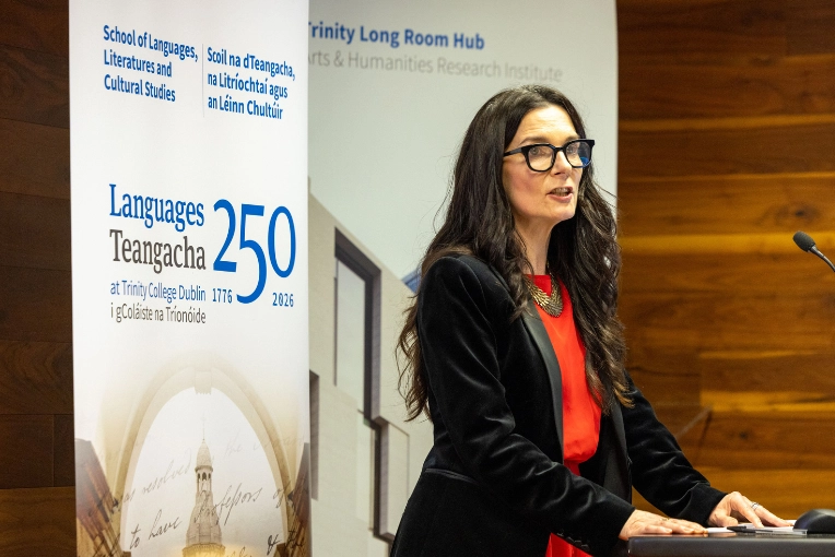 Professor Mary Cosgrove standing at a podium at the Opening Ceremony for Languages 250 at Trinity.