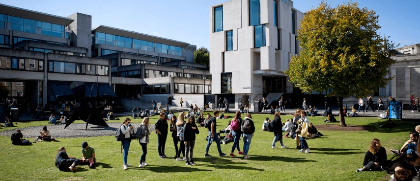 Students walking on Fellow's Square in front of the Arts Building.