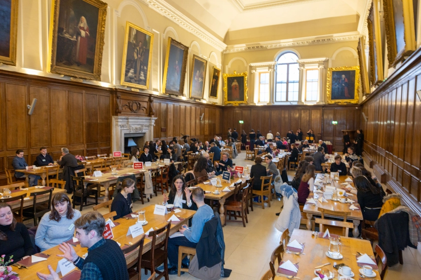 Alumni Breakfast General Picture people are seat around table in little discussion groups