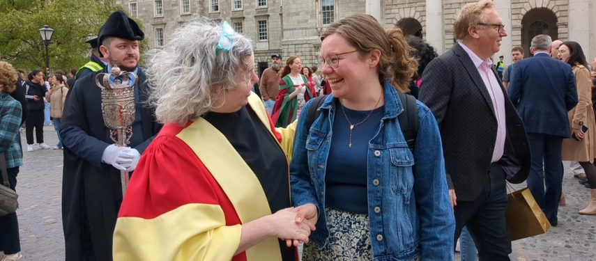 Provost shakes hands with Joy Byrne, a Scholar