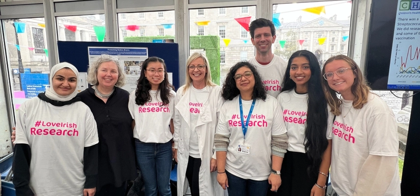 Linda standing for a photo with 7 people who are wearing white t-shirts with pink text reading '#LoveIrish Research.' They are all smiling at the camera.