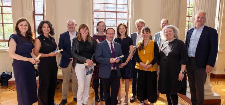 Large group of people all smiling at the camera.