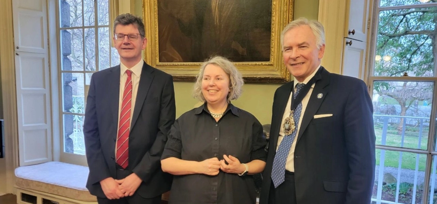 Three people smiling for the camera.