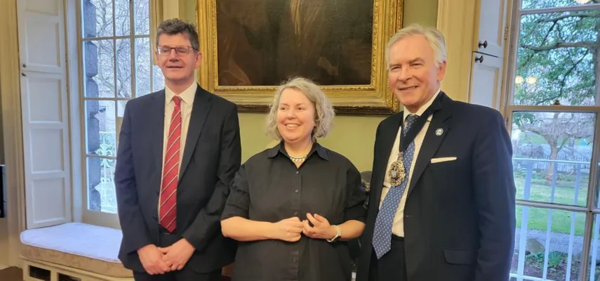 Three people smiling for the camera.