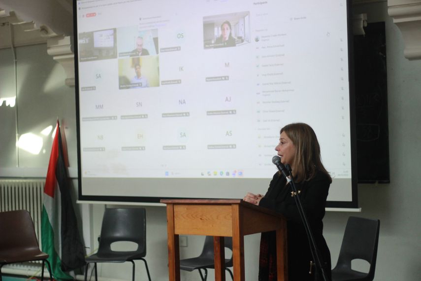 A presenter standing in front of a projected screen