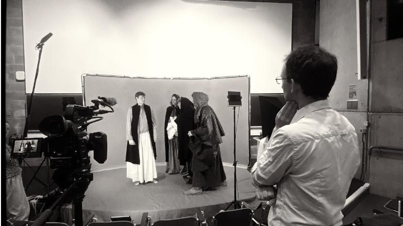 A group of Trinity students wearing historical dress on a film set.
