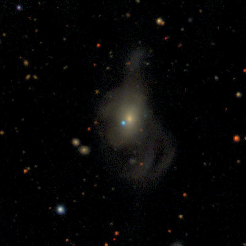 Zwicky Transient Facility composite image of supernova (SN) 2019yvq (blue dot in the center of the image) in the host galaxy NGC 4441 (large yellow galaxy in the center of the image), which is nearly 140 million light-years away from Earth. SN 2019yvq exhibited a rarely observed ultraviolet flash in the days after the star exploded.   Credit: ZTF/A. A. Miller (Northwestern) and D. Goldstein (Calte