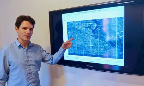 Image of Professor Chadefaux in front of a display screen