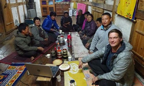 Image of Dr Tim Bodt sitting with people having a meal