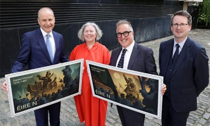 Image of Taoiseach, Provost, An Post CEO and Director of Trinity Long Room Hub with two large stamps at O'Connell stamp launch.