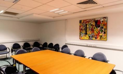 Room  b1.04.4. The room has a large conference desk with chairs in it