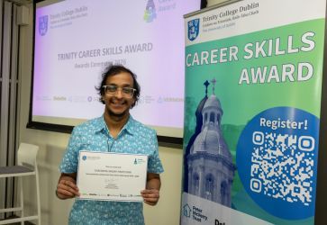 Student posing with Trinity Career Skills Award certificate