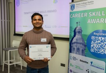 Student posing with Trinity Career Skills Award certificate