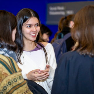 students talking to Trinity Alumni