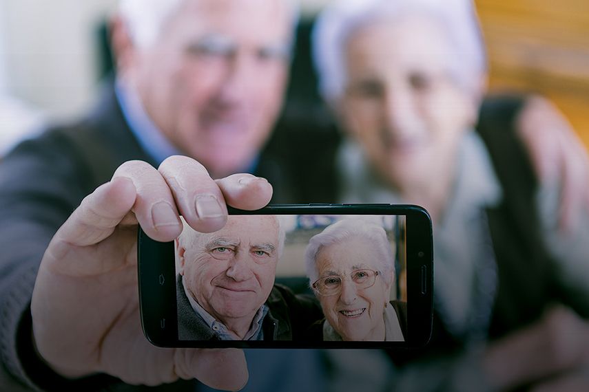 Elderly couple holding iphone