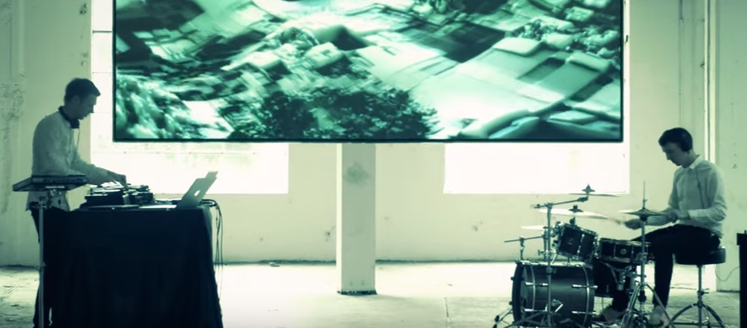Kormac performing on decks and with drums