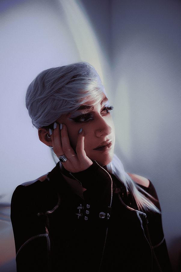 A portrait of a person resting their chin in their hand