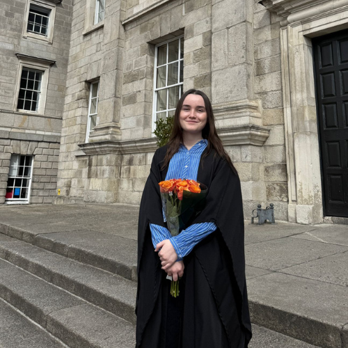 Scholar Caoimhe Hayes wearing academic robes.