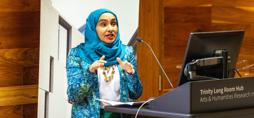 Thahmina Begum speaking at the podium.