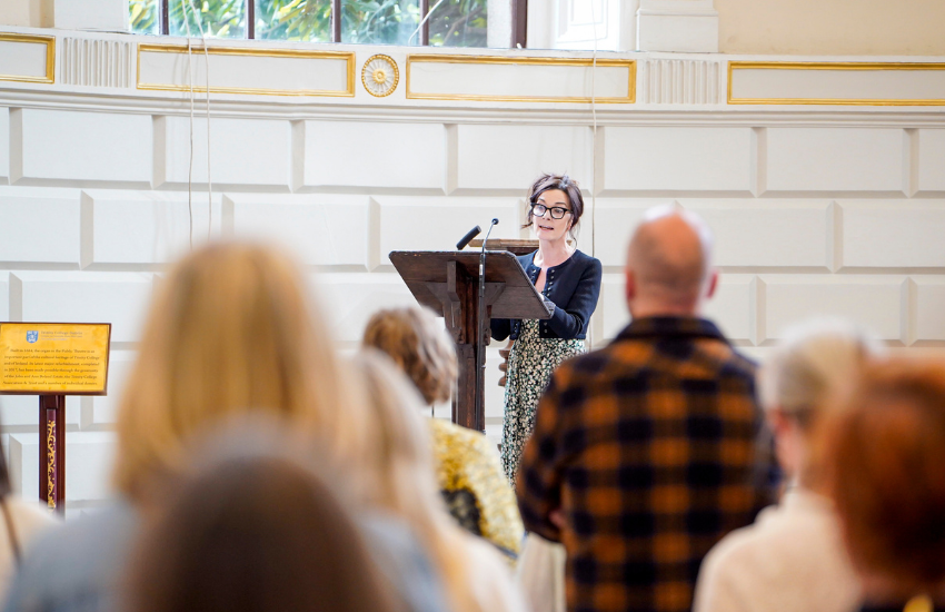 Professor Mary Cosgrove standing at a podium speaking.