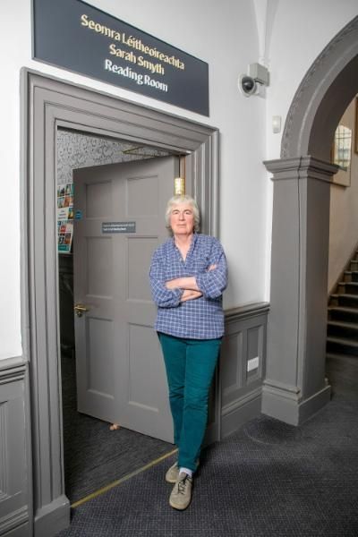 Sarah Smyth standing in the doorway of the reading room named in her honour at 36 Fenian Street.
