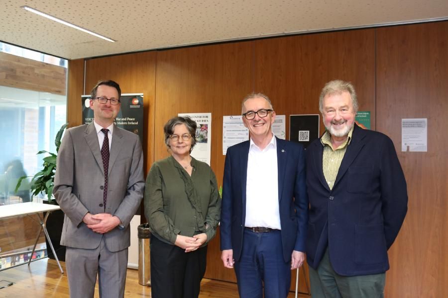 Prof Michael Cronin standing with Trinity Long Room Hub Director Prof Patrick Geoghegan, former Director Prof Eve Patten, and Chair of of the Trinity Long Room Hub Research Institute Board Prof Rick Rylance.
