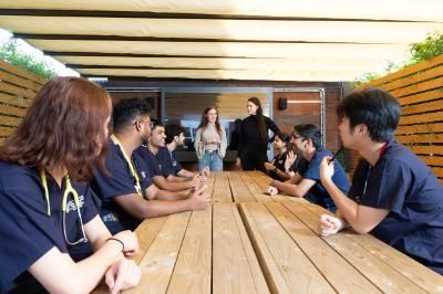 students getting lectured in an outdoor classroom