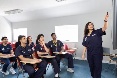 students getting lectured in a room