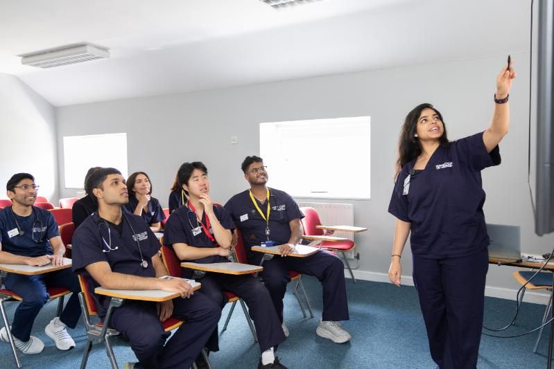 students getting lectured in a room