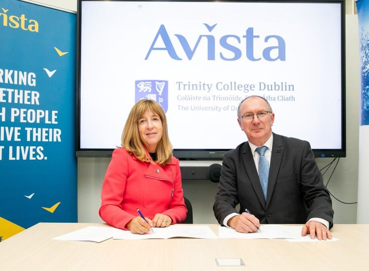 A man and a woman sign a document